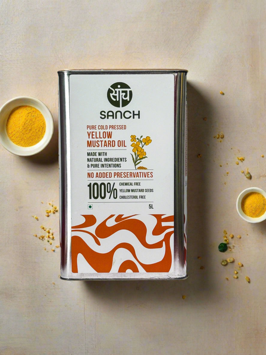 Sanch yellow mustard oil can on a wooden surface with a metallic background