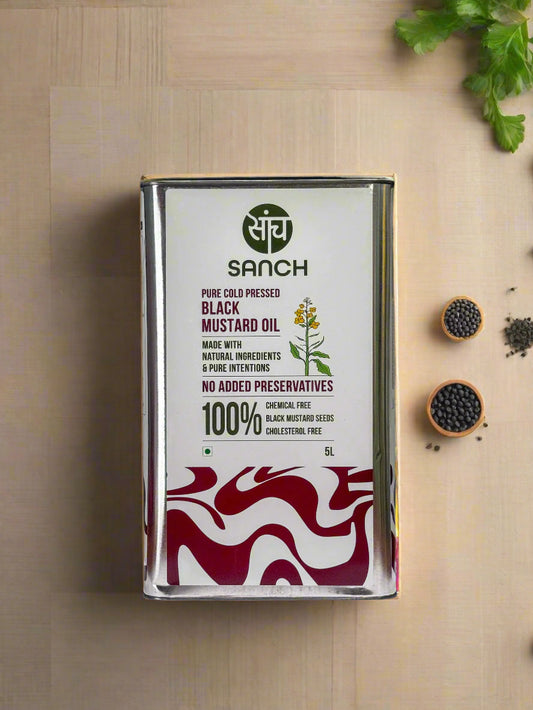 Sanch pure cold pressed black mustard oil container on a wooden surface with a metallic background